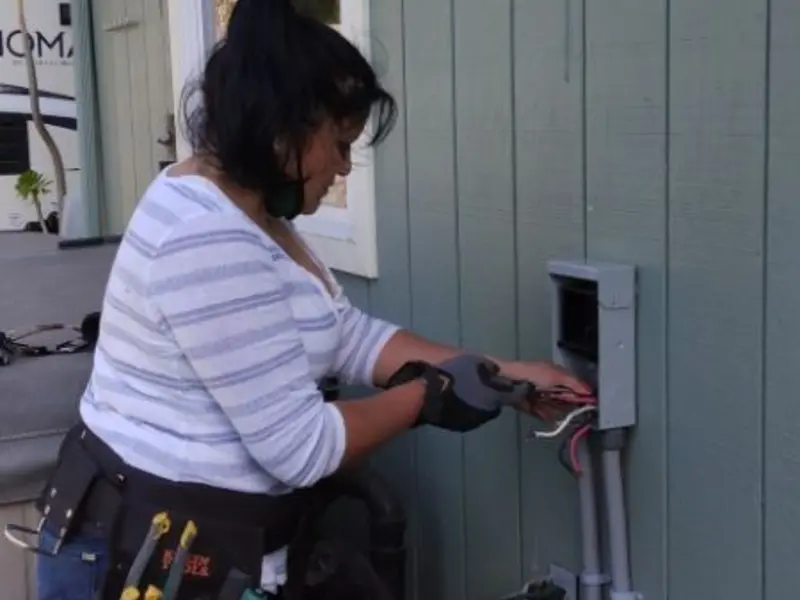 Licensed electrician wiring an exterior subpanel in Summit View