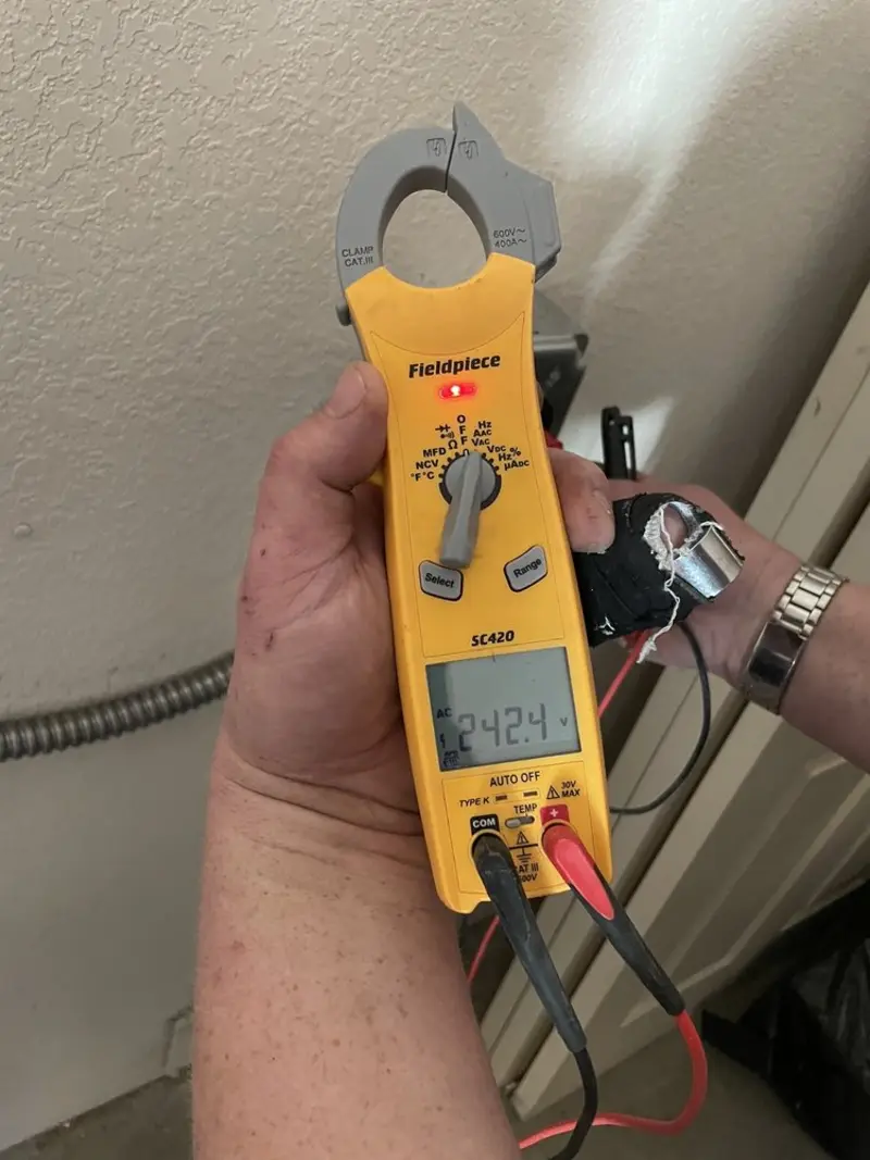 Voltage testing with clamp meter during Outlet Installation in Summit View